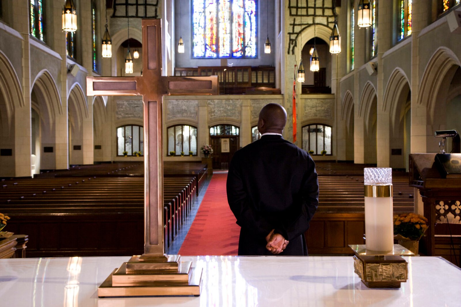 Person facing altar in empty church