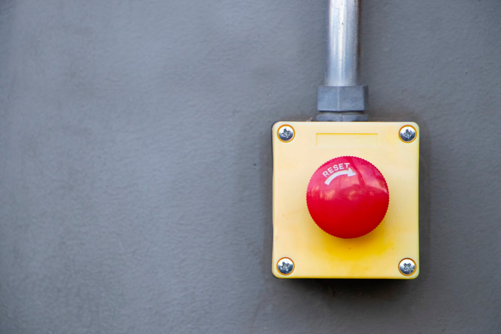 Emergency reset button on industrial wall