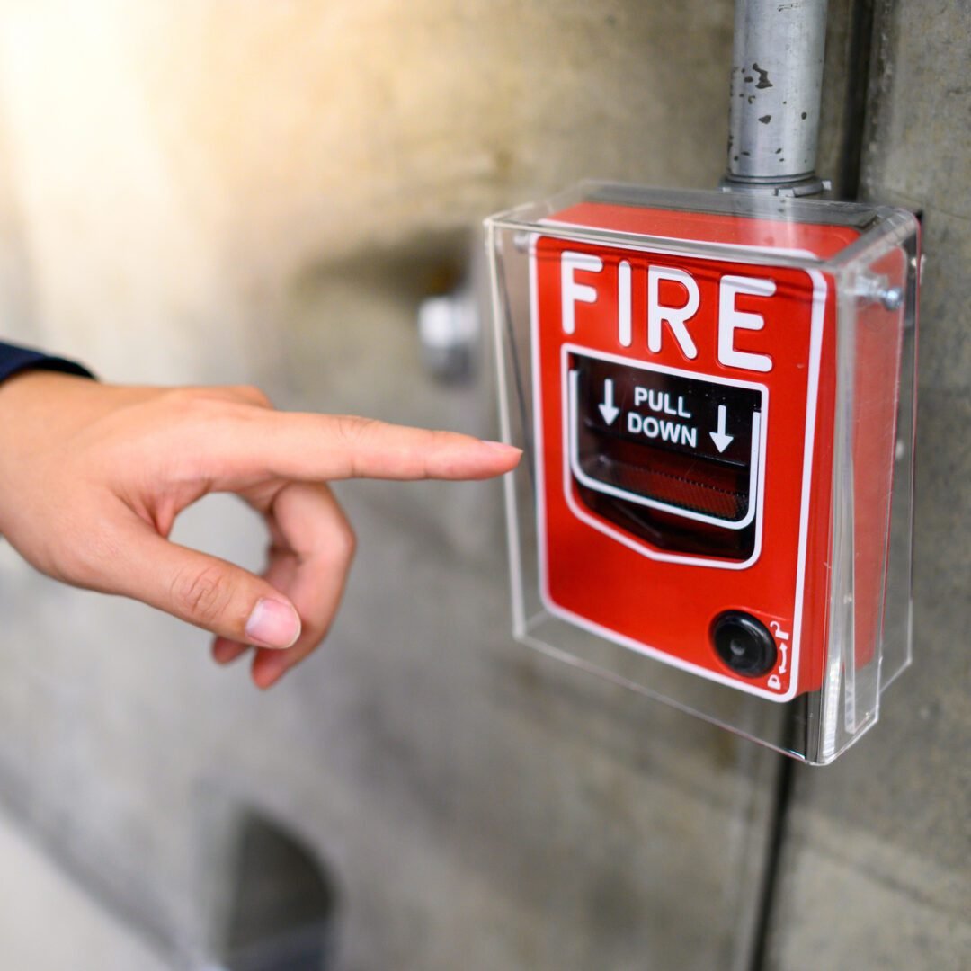 Person about to pull fire alarm