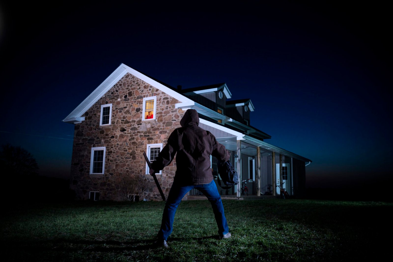 Suspenseful scene outside a stone house