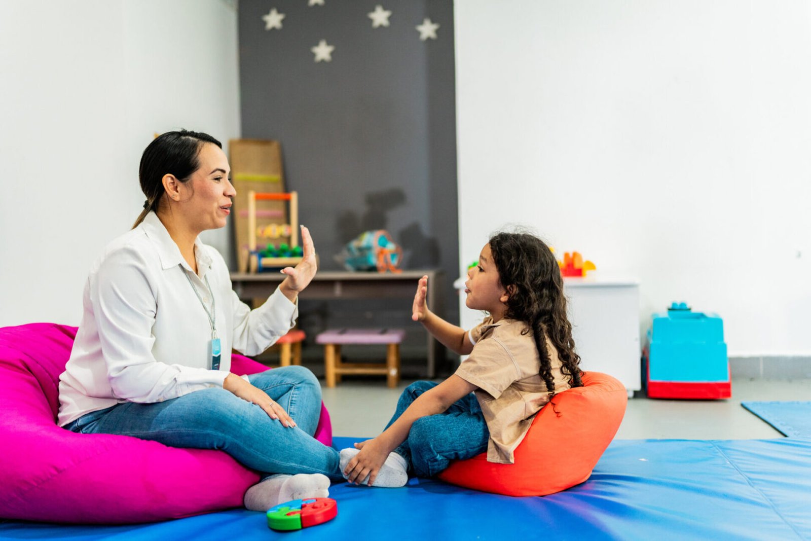 Teacher and student interacting in playroom