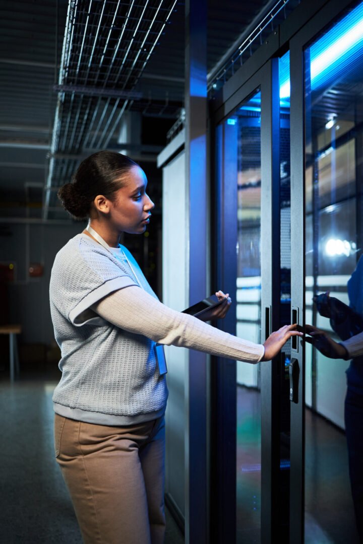 Woman opening a door with a security system server.
