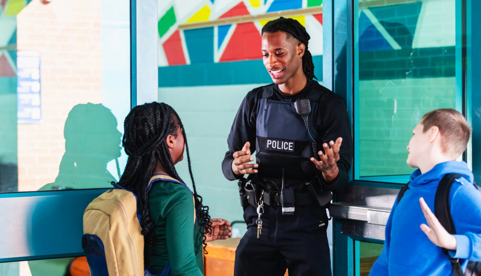 Police officer talking to school children
