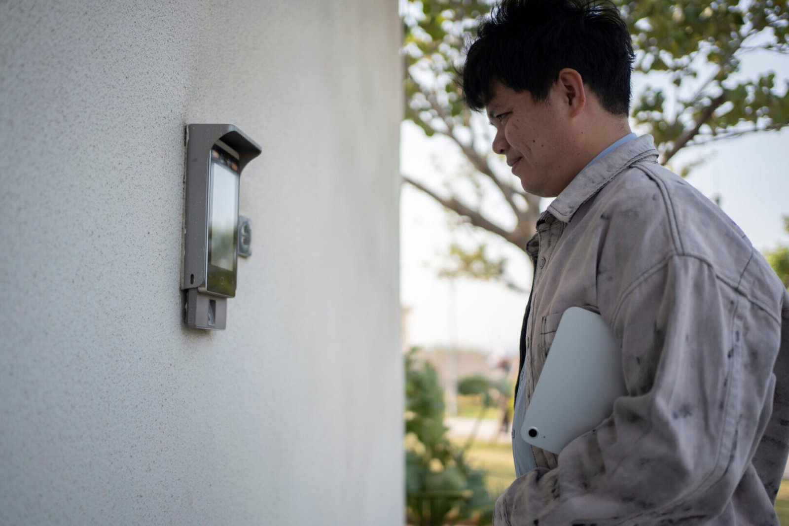 Person holding tablet near intercom