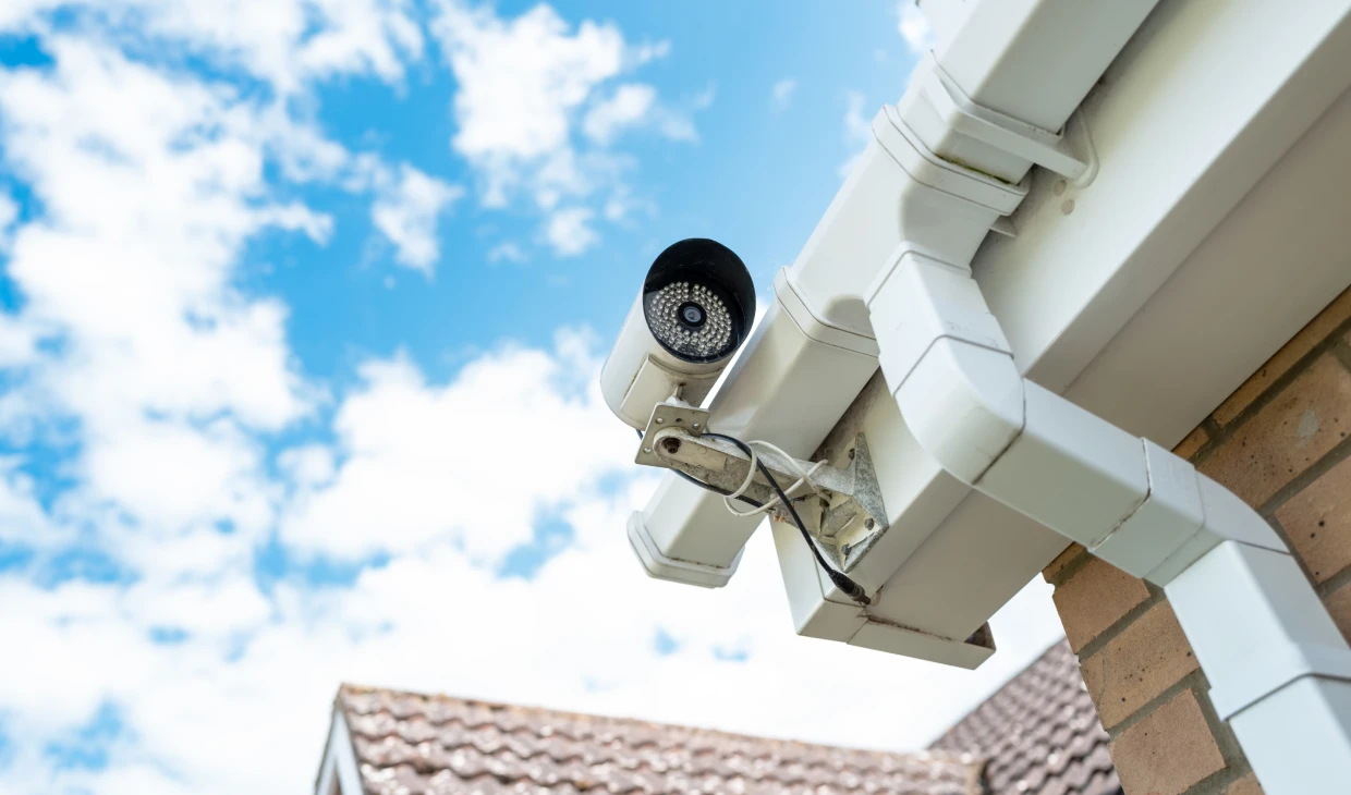Security camera on house under blue sky