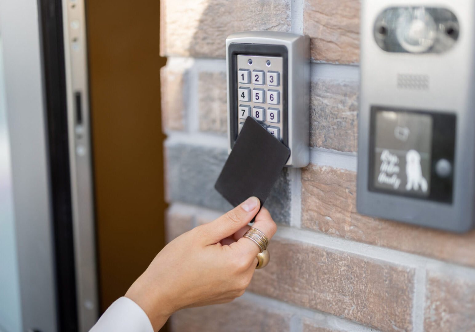 Person using RFID card on keypad access control.