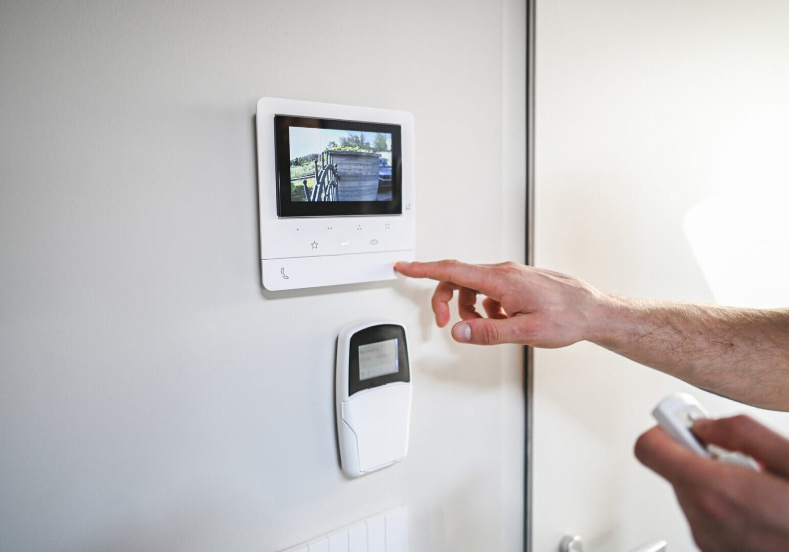 Person operating home security control panel.